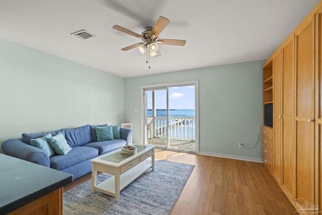 living room with ceiling fan and hardwood / wood-style floors