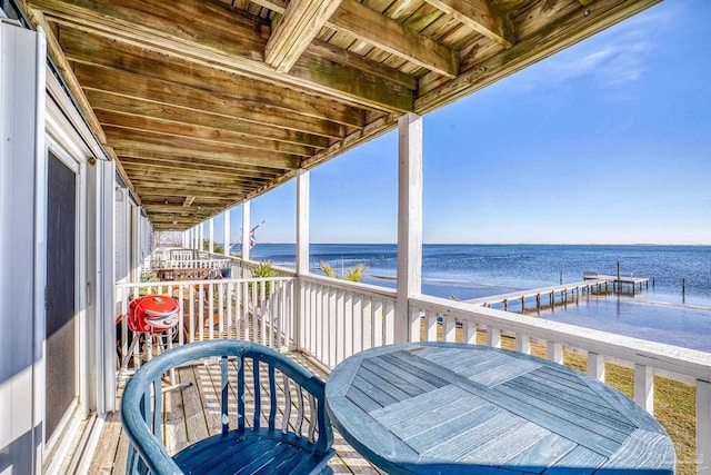 wooden terrace featuring a water view