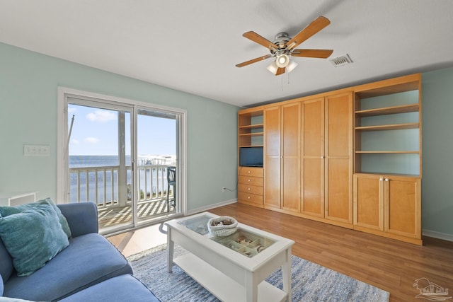 living room with ceiling fan and light hardwood / wood-style floors