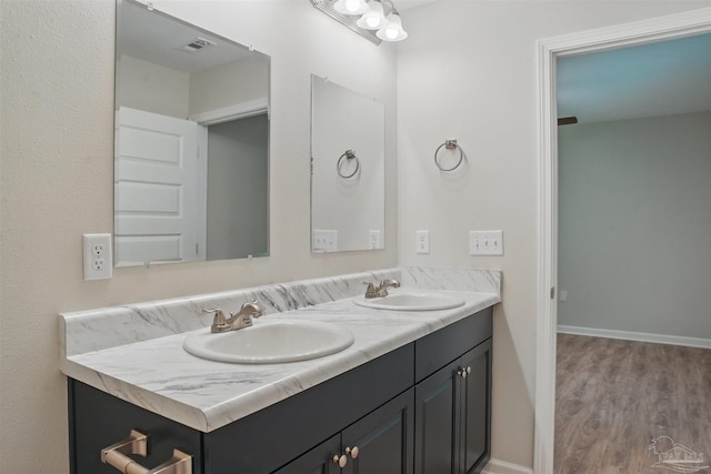 1002 Yonge St, Pensacola, FL 32501 - bathroom with wood finished floors, double vanity, and baseboards