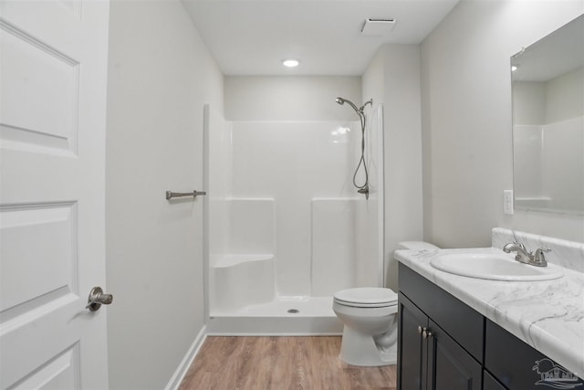 1002 Yonge St, Pensacola, FL 32501 - full bath with wood finished floors, a shower, toilet, vanity, and baseboards