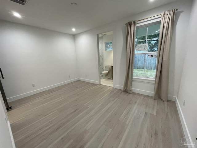 spare room with light wood-type flooring