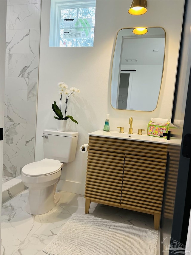 bathroom featuring toilet, vanity, and walk in shower