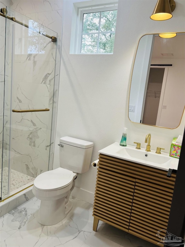 bathroom featuring marble finish floor, vanity, a marble finish shower, and toilet