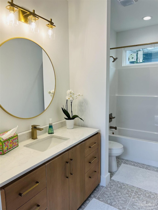 full bathroom with washtub / shower combination, tile patterned flooring, vanity, and toilet