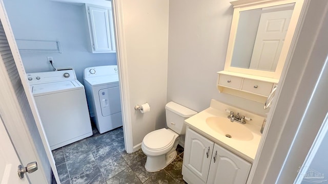 2708 Willow Grove Ln, Ft Walton Beach, FL 32547 - bathroom featuring washing machine and clothes dryer, toilet, vanity, and baseboards