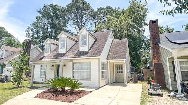 2708 Willow Grove Ln, Ft Walton Beach, FL 32547 - cape cod-style house featuring central AC unit, roof with shingles, and driveway