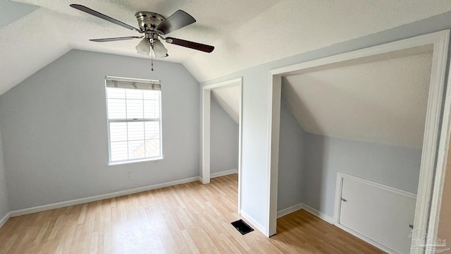 2708 Willow Grove Ln, Ft Walton Beach, FL 32547 - bonus room with light wood-type flooring, lofted ceiling, a ceiling fan, baseboards, and a textured ceiling