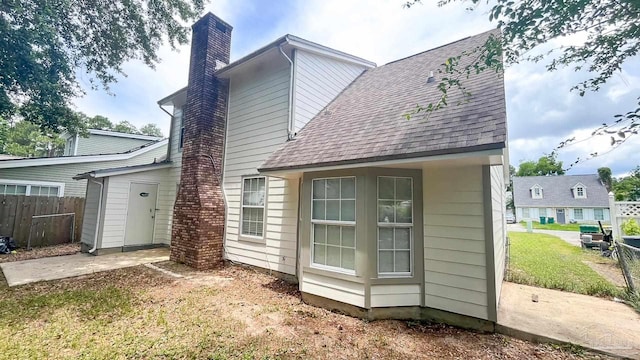2708 Willow Grove Ln, Ft Walton Beach, FL 32547 - back of property featuring a chimney and roof with shingles