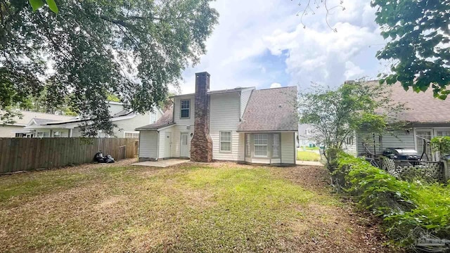 2708 Willow Grove Ln, Ft Walton Beach, FL 32547 - rear view of house with a chimney and roof with shingles