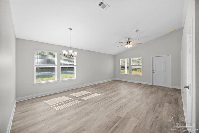 interior space featuring light hardwood / wood-style flooring, lofted ceiling, and ceiling fan with notable chandelier