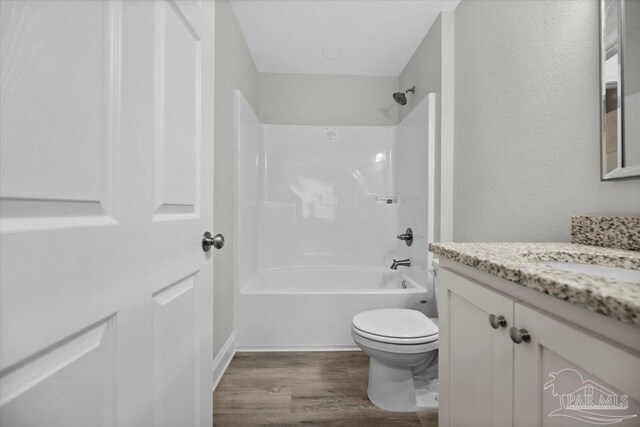 full bathroom featuring toilet, shower / tub combination, vanity, and hardwood / wood-style floors