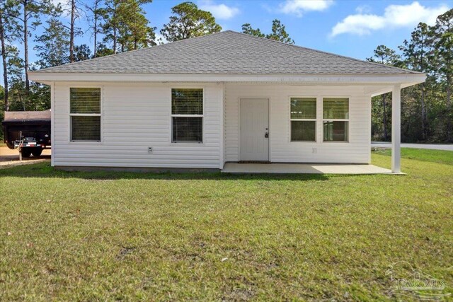 back of property featuring a lawn