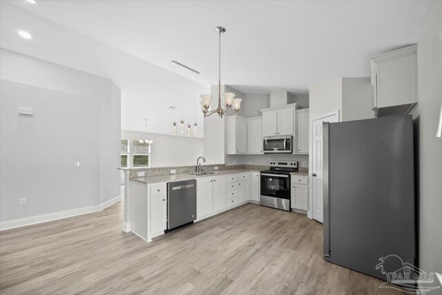 kitchen featuring light hardwood / wood-style flooring, stainless steel appliances, sink, pendant lighting, and white cabinets