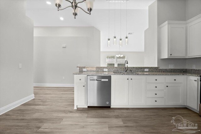 kitchen featuring dishwasher, sink, white cabinetry, decorative light fixtures, and light hardwood / wood-style flooring