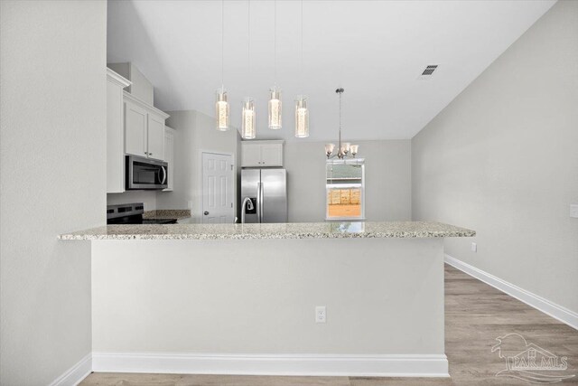 kitchen with kitchen peninsula, white cabinetry, stainless steel appliances, and light wood-type flooring