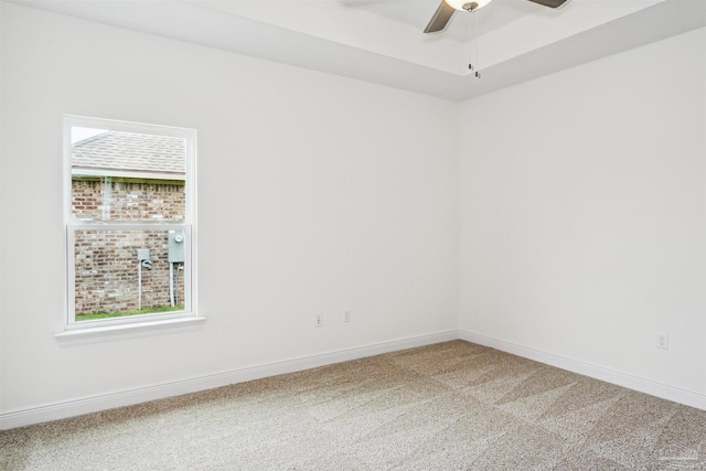 carpeted empty room with baseboards and ceiling fan