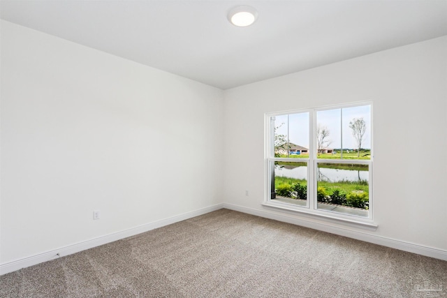 carpeted empty room with baseboards