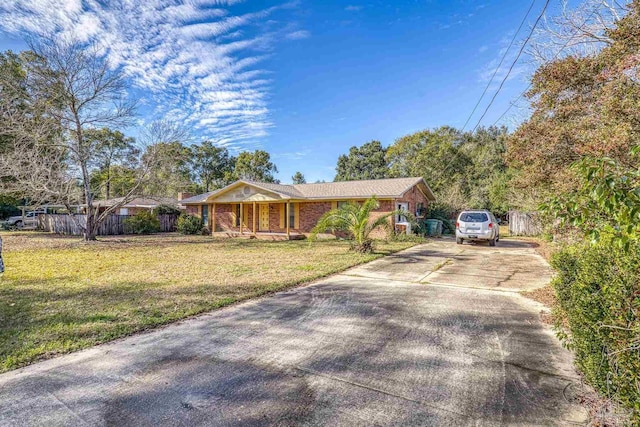 ranch-style house with covered porch and a front lawn