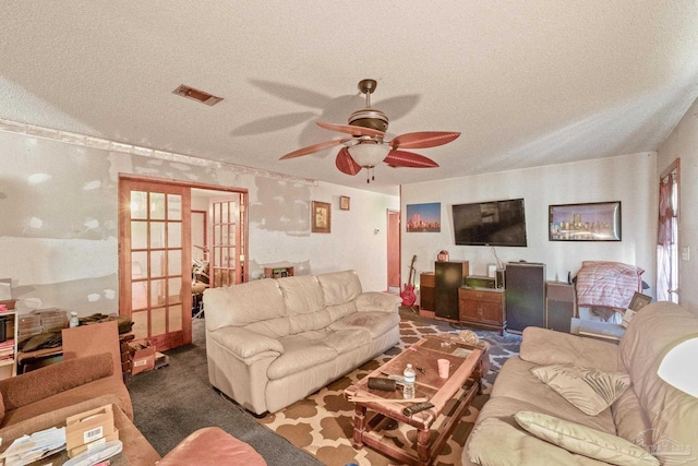 living room featuring carpet floors, ceiling fan, a textured ceiling, and french doors