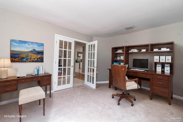 carpeted home office with french doors