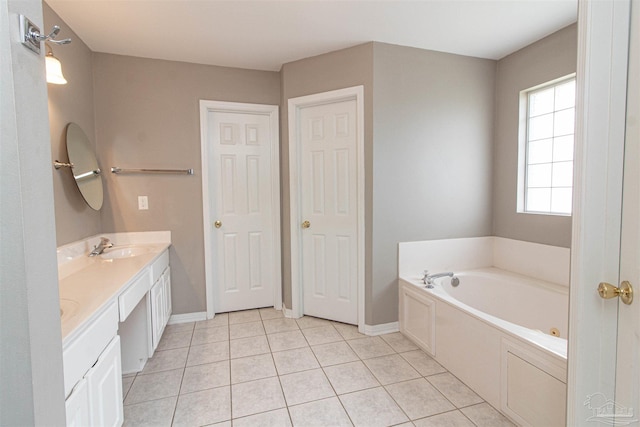 bathroom featuring vanity, tile patterned flooring, and a bathing tub