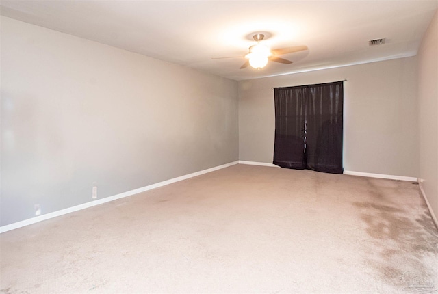 carpeted spare room with ceiling fan