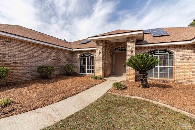 view of front of property featuring solar panels