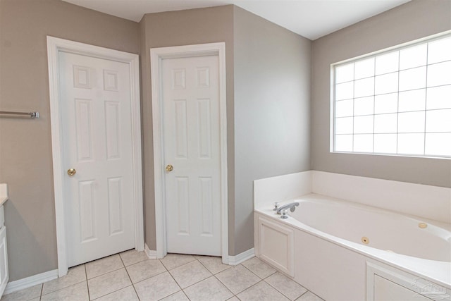 bathroom featuring tile patterned floors and a bath