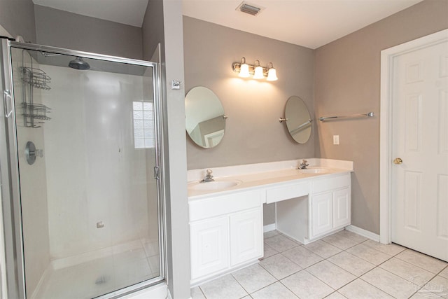 bathroom featuring vanity, tile patterned floors, and a shower with door