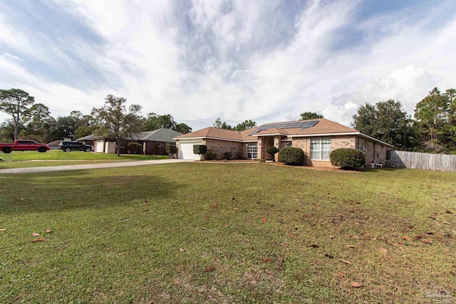 ranch-style home featuring a garage and a front lawn