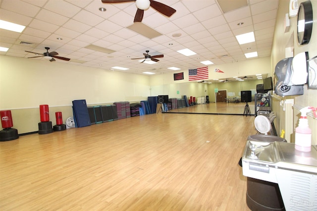 misc room with a drop ceiling and wood-type flooring