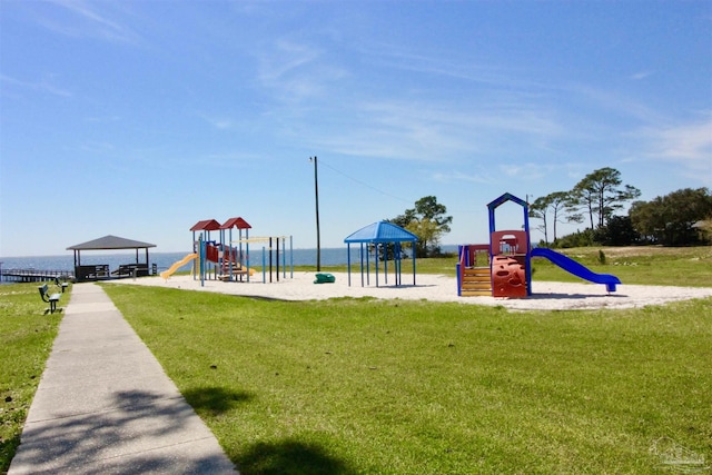 view of playground featuring a water view and a lawn