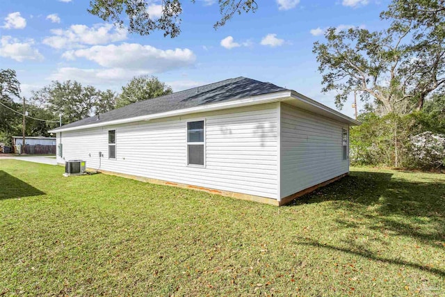 view of home's exterior featuring cooling unit and a lawn