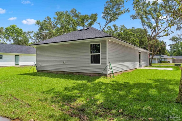 view of side of home with a yard