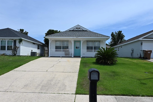 5577 Shadow Shore Pl, Gulf Breeze, FL 32563 - view of front facade with a porch, a front yard, central AC unit, a shingled roof, and driveway