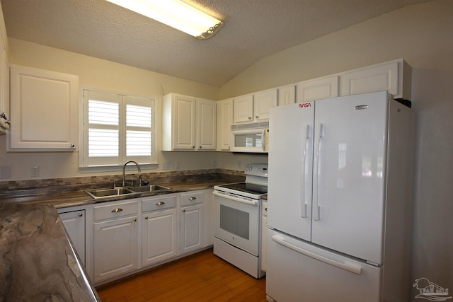 5577 Shadow Shore Pl, Gulf Breeze, FL 32563 - kitchen with white appliances, a sink, white cabinets, dark countertops, and lofted ceiling