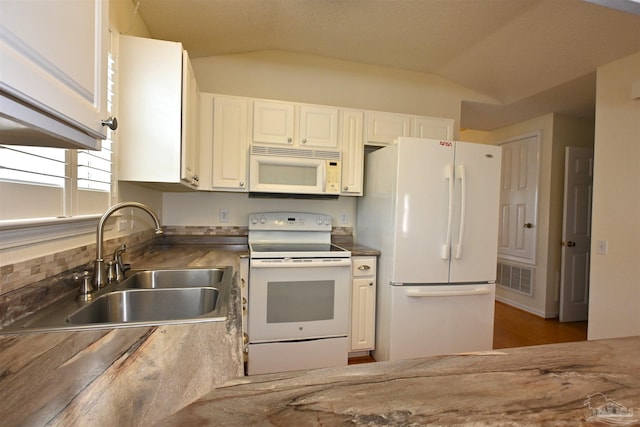 5577 Shadow Shore Pl, Gulf Breeze, FL 32563 - kitchen featuring white appliances, a sink, lofted ceiling, and white cabinets
