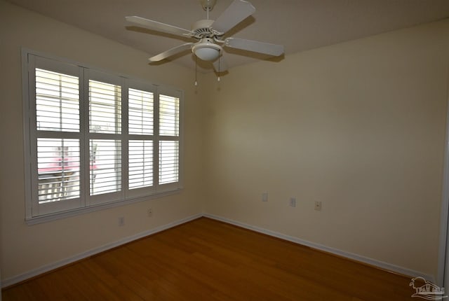 5577 Shadow Shore Pl, Gulf Breeze, FL 32563 - empty room featuring baseboards, wood finished floors, and a ceiling fan