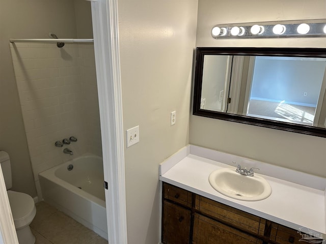 full bathroom with toilet, tile patterned floors, tiled shower / bath, and vanity