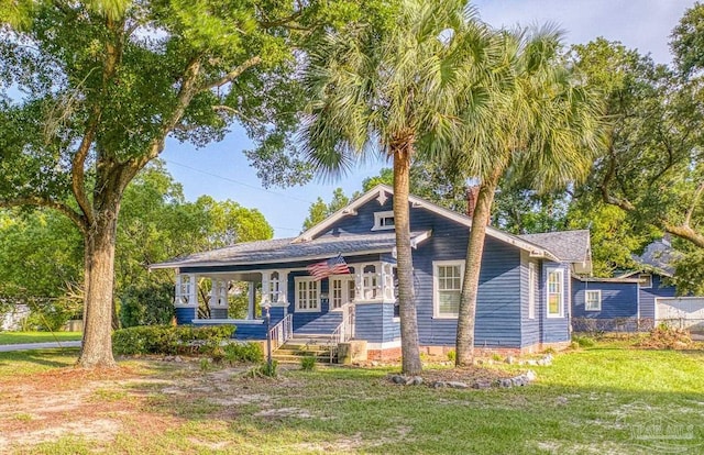 view of front facade with a front yard and a porch