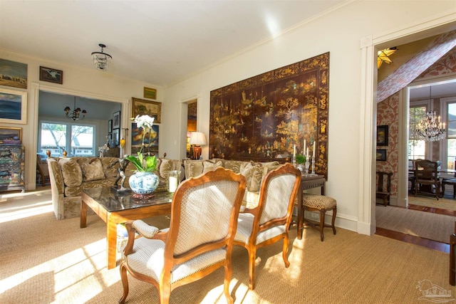 dining space featuring baseboards, visible vents, light colored carpet, ornamental molding, and a notable chandelier