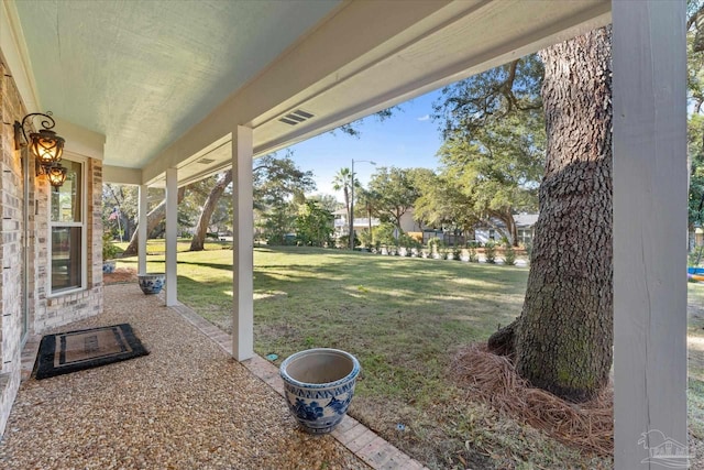 view of yard featuring covered porch