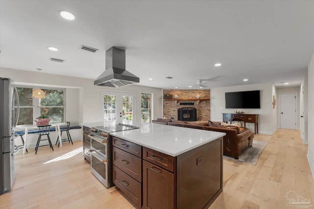 kitchen with ceiling fan, french doors, extractor fan, appliances with stainless steel finishes, and light wood-type flooring