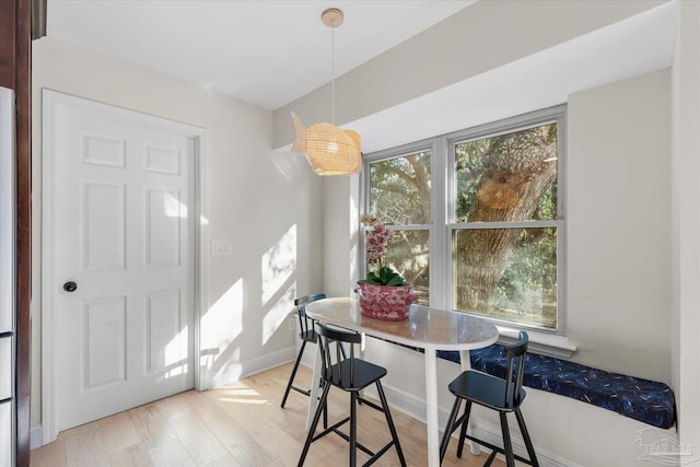 dining space with plenty of natural light and light hardwood / wood-style flooring