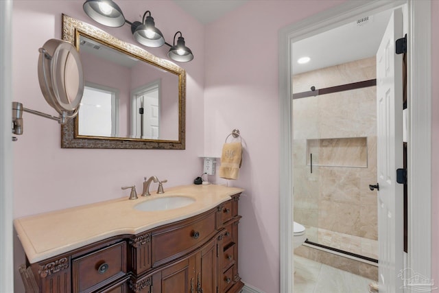 bathroom with tile patterned flooring, vanity, toilet, and walk in shower