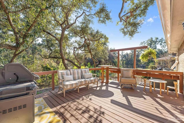 deck featuring outdoor lounge area and grilling area