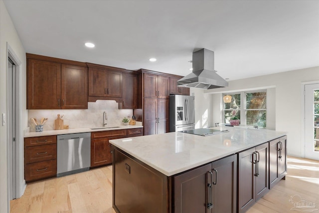 kitchen featuring backsplash, sink, an island with sink, island exhaust hood, and stainless steel appliances