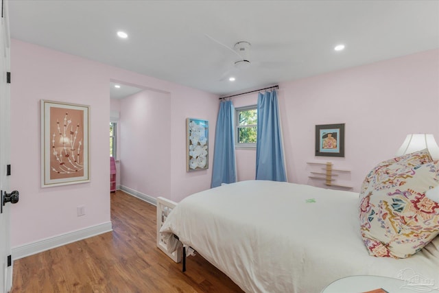 bedroom with wood-type flooring and ceiling fan