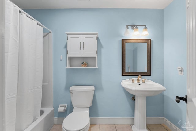 bathroom featuring tile patterned floors, shower / tub combo with curtain, and toilet